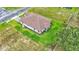Single-story house; brown tile roof; grassy backyard at 574 Loblolly Pl, Auburndale, FL 33823