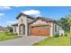 One story home with brown garage door and tile roof at 574 Loblolly Pl, Auburndale, FL 33823