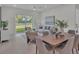 Spacious dining area with a wooden table and access to the backyard at 574 Loblolly Pl, Auburndale, FL 33823