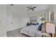 Bright bedroom with a queen bed, two armchairs, and large window at 574 Loblolly Pl, Auburndale, FL 33823