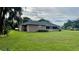 Large backyard with spacious lawn and home exterior view at 4107 Timberlake E Rd, Lakeland, FL 33810