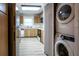 View of kitchen with appliances and stackable washer and dryer at 832 S Hill Ave # 10, Deland, FL 32724