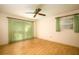 Bedroom with light wood floors, ceiling fan and large window at 832 S Hill Ave # 10, Deland, FL 32724