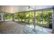 Bright screened porch with glass windows overlooking a lush garden at 832 S Hill Ave # 10, Deland, FL 32724