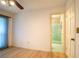 Bedroom with light wood floors, ceiling fan, and access to bathroom at 832 S Hill Ave # 10, Deland, FL 32724