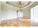 Spacious bedroom with wood-look floors and ceiling fan at 2636 Huntington Hills Dr, Lakeland, FL 33810