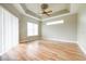 Bright bedroom with wood-look tile floors and large window at 2636 Huntington Hills Dr, Lakeland, FL 33810