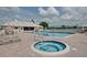 Community pool and spa with surrounding lounge chairs at 2636 Huntington Hills Dr, Lakeland, FL 33810