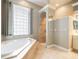 Bathroom boasts a large garden tub and walk-in shower at 2636 Huntington Hills Dr, Lakeland, FL 33810