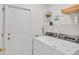 Convenient laundry room with washer, dryer, and shelving at 6545 Lake Clark Dr, Lakeland, FL 33813