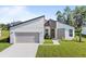 Newly built home with a modern design and attached garage at 266 Hyacinth Ct, Kissimmee, FL 34759