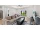 Bright living room featuring a sectional sofa, coffee table, and a view of the backyard at 266 Hyacinth Ct, Kissimmee, FL 34759