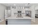 Modern kitchen with island, stainless steel appliances and white cabinets at 266 Hyacinth Ct, Kissimmee, FL 34759
