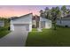 Modern house exterior, featuring a clean design and a well-manicured lawn at 266 Hyacinth Ct, Kissimmee, FL 34759