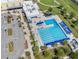 Aerial view of community pool with lap lanes, deck chairs, and surrounding landscaping at 266 Hyacinth Ct, Kissimmee, FL 34759