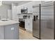 Stainless steel appliances and white cabinetry in this modern kitchen at 266 Hyacinth Ct, Kissimmee, FL 34759