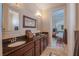 Bathroom with double vanity, granite countertop, and view of bedroom at 7330 Reflections Lake Dr, Lakeland, FL 33813