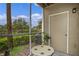 Screened porch with small table and AC unit at 4255 Summer Landing Dr # 106, Lakeland, FL 33810