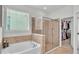 Bathroom with soaking tub, walk-in shower, and large closet at 4184 Prima Lago Cir, Lakeland, FL 33810