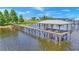 Long wooden dock extending over calm lake water, offering ample space for boats at 7884 N Lake Buffum Shores Rd, Fort Meade, FL 33841