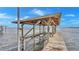 Covered boat lift on a wooden dock at 7884 N Lake Buffum Shores Rd, Fort Meade, FL 33841