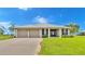 Single story home with attached two-car garage, and a spacious lawn at 7884 N Lake Buffum Shores Rd, Fort Meade, FL 33841