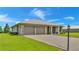 Single-story house with two-car garage, metal roof, and lush green lawn at 7884 N Lake Buffum Shores Rd, Fort Meade, FL 33841