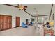 Spacious living room featuring high ceilings, tile floors, and ample natural light at 7884 N Lake Buffum Shores Rd, Fort Meade, FL 33841