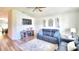 Relaxing living room with navy blue reclining sofas, wood floors, and fireplace at 1268 Pintail Pl, Lakeland, FL 33813