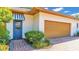 Attached garage with a blue door and striped awning at 3904 Cheverly E Dr, Lakeland, FL 33813