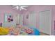 Bedroom with pink walls, double closet and colorful bedding at 3904 Cheverly E Dr, Lakeland, FL 33813