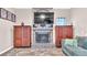 Stone fireplace as a focal point in the living room, flanked by wooden cabinets at 3904 Cheverly E Dr, Lakeland, FL 33813