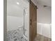 Modern bathroom with barn door, patterned floor tile and walk-in shower at 1096 Drew St, Lakeland, FL 33810