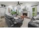 Spacious living room with fireplace, leather sofas, and a large TV at 1096 Drew St, Lakeland, FL 33810