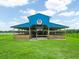 Blue metal horse barn with stalls and riding arena at 1096 Drew St, Lakeland, FL 33810