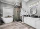 Bathroom with freestanding tub, walk-in shower, and modern cabinetry at 1096 Drew St, Lakeland, FL 33810