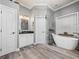 Bathroom with a large soaking tub and white cabinets at 1096 Drew St, Lakeland, FL 33810