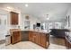 Kitchen with dark brown cabinets, granite countertops, and island at 1113 Allegro Pl, Dundee, FL 33838