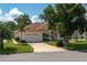 Single-story home with a large driveway and landscaped yard at 6803 Hermitage Dr, Lakeland, FL 33810