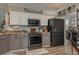 Modern kitchen with gray cabinets and granite countertops at 6803 Hermitage Dr Dr, Lakeland, FL 33810