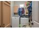 Bright laundry room with washer, dryer, and ample storage at 6803 Hermitage Dr, Lakeland, FL 33810