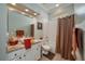 Clean bathroom with a shower/tub combo and granite vanity at 6803 Hermitage Dr, Lakeland, FL 33810