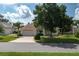 Single story house with a two-car garage and lush landscaping at 6803 Hermitage Dr, Lakeland, FL 33810