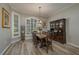 Formal dining room with hardwood floors and large windows at 6803 Hermitage Dr, Lakeland, FL 33810