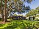 House exterior with large oak trees and lush landscaping at 1323 Hammock Shade Dr, Lakeland, FL 33809
