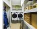 Laundry room with washer, dryer, shelving, and extra storage at 1323 Hammock Shade Dr, Lakeland, FL 33809
