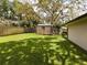 Large backyard with shed and spacious green lawn at 1323 Hammock Shade Dr, Lakeland, FL 33809