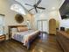 Spacious bedroom with hardwood floors, large windows, and a ceiling fan at 1323 Hammock Shade Dr, Lakeland, FL 33809
