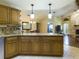 Open kitchen features island with seating and granite countertops at 1323 Hammock Shade Dr, Lakeland, FL 33809