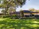 Single story home with mature landscaping and a spacious lawn at 1323 Hammock Shade Dr, Lakeland, FL 33809